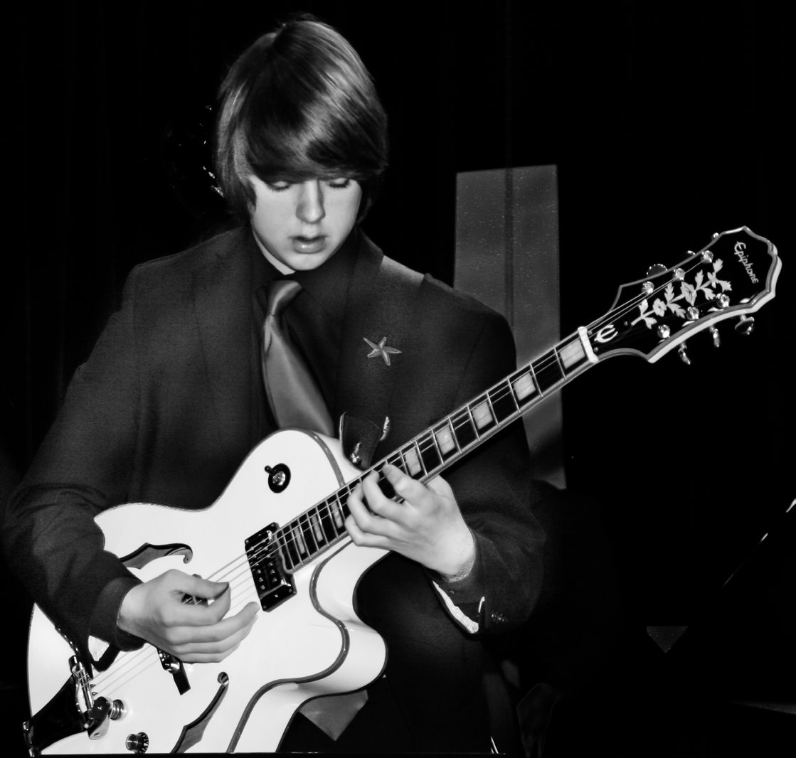Niko Winchell Performing Solo Niko Winchell Performing a Solo on Guitar